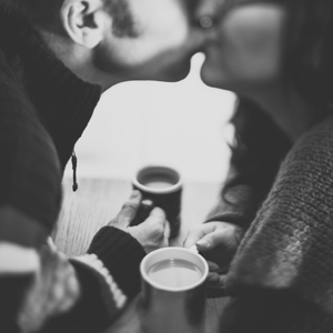Stock photo of couple kissing over coffee for Scientists prove that sweet talk works written by Anna Mouton. Photo by Nathan Walker.